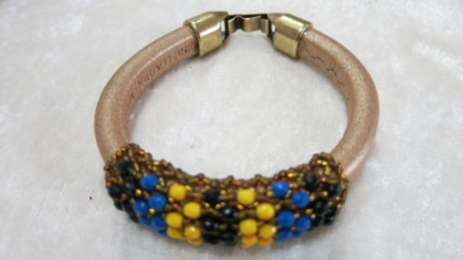 Leather bangle with netted beads laying
