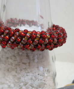 bracelet rolled crochet style red transparent on bottle